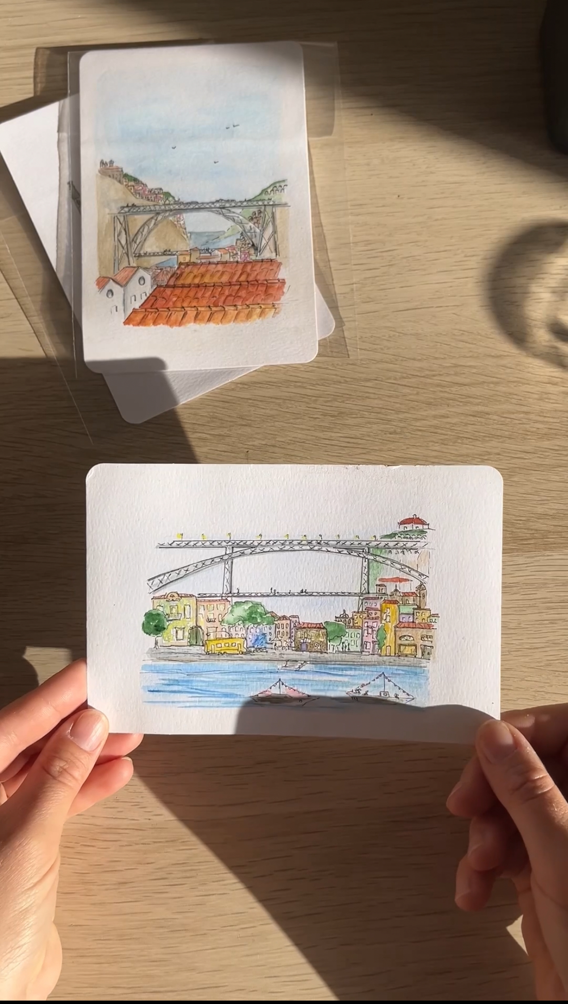 Porto skyline postcard showing the famous bridge, illustrated in soft pastel and watercolor with oats in Douro river.